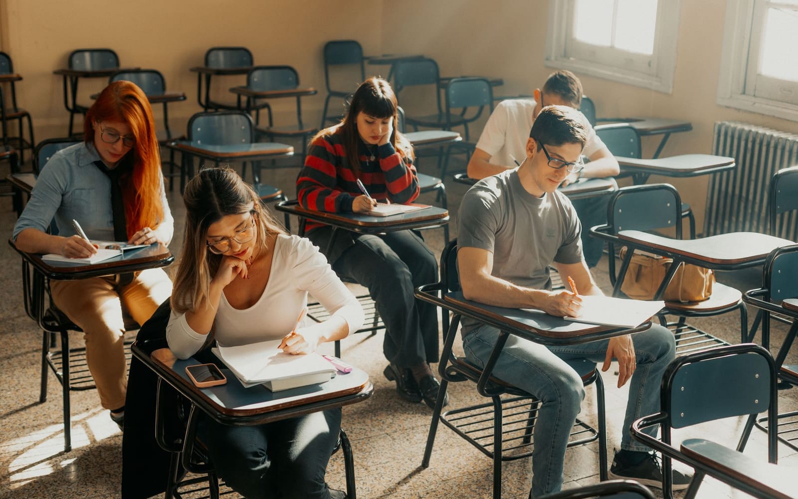 Adult learners sitting an exam in a classroom